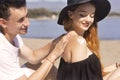 Couple on a summer beach vacation have good skincare with high spf sunblock, sun cream. Couple applying suncream. Royalty Free Stock Photo