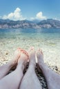 Couple in the summer holidays: Feet in the crystal clear water