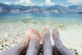 Couple in the summer holidays: Feet in the crystal clear water