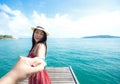 Couple summer vacation travel, Woman walking on romantic honeymoon and relax on the wood bridge near beach in holidays holding han Royalty Free Stock Photo