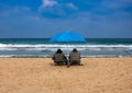 Couple in sunbeds relax on a sea beach Royalty Free Stock Photo