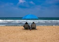 Couple in sunbeds relax on a sea beach Royalty Free Stock Photo