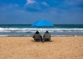 Couple in sunbeds relax on a sea beach Royalty Free Stock Photo