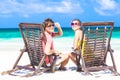 Couple in sunglasses on sun lounger on tropical Royalty Free Stock Photo