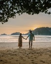 Couple during sunset on the beach Krabi Thailand, men and woman watching sunset at Ao Nam Mao beach Krabi Ao Nang area Royalty Free Stock Photo