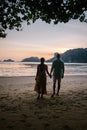 Couple during sunset on the beach Krabi Thailand, men and woman watching sunset at Ao Nam Mao beach Krabi Ao Nang area Royalty Free Stock Photo