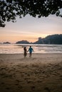 Couple during sunset on the beach Krabi Thailand, men and woman watching sunset at Ao Nam Mao beach Krabi Ao Nang area Royalty Free Stock Photo