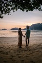 Couple during sunset on the beach Krabi Thailand, men and woman watching sunset at Ao Nam Mao beach Krabi Ao Nang area Royalty Free Stock Photo