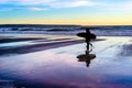 Couple with surfboards at sunset Royalty Free Stock Photo