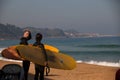 A couple of surfers with their boards in Zarautz.