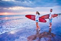 Couple of surfers walking on coast in Indonesia Royalty Free Stock Photo