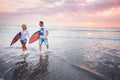 Couple of surfers walking on coast in Indonesia Royalty Free Stock Photo