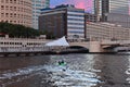 Couple surfing on jet ski, with view of hotels, skyscrapers and bridge. Royalty Free Stock Photo