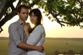 Couple sweethearts under tree at summer