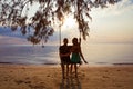 Couple on a swing against of sunset Royalty Free Stock Photo