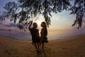 Couple on a swing against of sunset Royalty Free Stock Photo