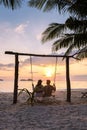 couple on a swing on the beach of Koh Chang Thailand during sunset Royalty Free Stock Photo