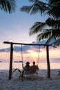 couple on a swing on the beach of Koh Chang Thailand during sunset Royalty Free Stock Photo