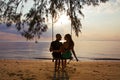 Couple on a swing at sunset Royalty Free Stock Photo