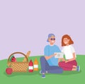 Couple with tablet with basket food grass picnic