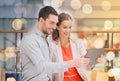 Couple with tablet pc and shopping bags in mall Royalty Free Stock Photo