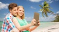 Couple with tablet pc taking selfie over beach Royalty Free Stock Photo