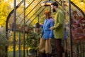 Couple take care of plants in small orangery Royalty Free Stock Photo
