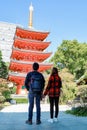 Couple take hands in front of Tochoji Temple