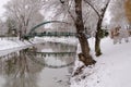 A couple takes pictures on the bridge after a snowfall on the city