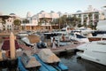 Couple takes a romantic sunset stroll along the marina in Park Hyatt Golf and Yacht Club. Exterior of luxury Mediterranean hotel.