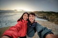 Couple takes selfie image at coastal scenery near Dunedin in New Zealand