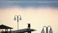 Couple takes selfy on a pier on a lake prespa in macedonia.sunset over lake .