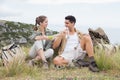 Couple taking break after hiking uphill Royalty Free Stock Photo