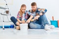 Couple taking a break from painting the walls Royalty Free Stock Photo
