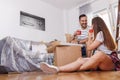 Couple taking a coffee break while moving in new apartment