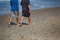 A couple taking morning walk at South Goa beach at sunrise