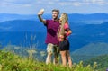 Couple taking photo. Couple in love hiking mountains. Lets take photo. Capturing beauty. Man and woman posing mobile Royalty Free Stock Photo