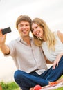 Couple taking photo of themselves with smart phone on romantic p Royalty Free Stock Photo