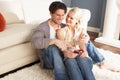 Couple Taking Photograph On Digital Camera At Home Royalty Free Stock Photo