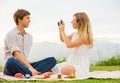 Couple taking photos of each other with retro vintage camera on Royalty Free Stock Photo