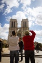 Couple taking pictures of Notre-Dame