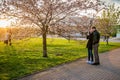 Couple taking pictures of Sakura blooming, Vilnius