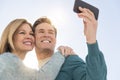 Couple Taking Self Portrait Through Cell Phone