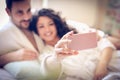 Couple taking self portrait. Focus on hand. Royalty Free Stock Photo