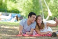 couple taking selfie on blanket in park Royalty Free Stock Photo