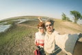 Couple taking selfie on Chobe River, Namibia Botswana border, Africa. Fisheye view from above, toned image. Chobe National Park