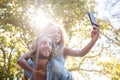 Couple taking selfie while enjoying piggyback ride Royalty Free Stock Photo