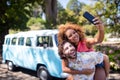 Couple taking selfie while enjoying piggyback ride Royalty Free Stock Photo