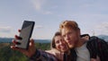 Couple taking selfie on mobile phone. Friends making happy faces on camera Royalty Free Stock Photo