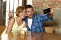 Couple taking selfie photo with mobile phone at coffee shop smiling happy in romance love concept Royalty Free Stock Photo